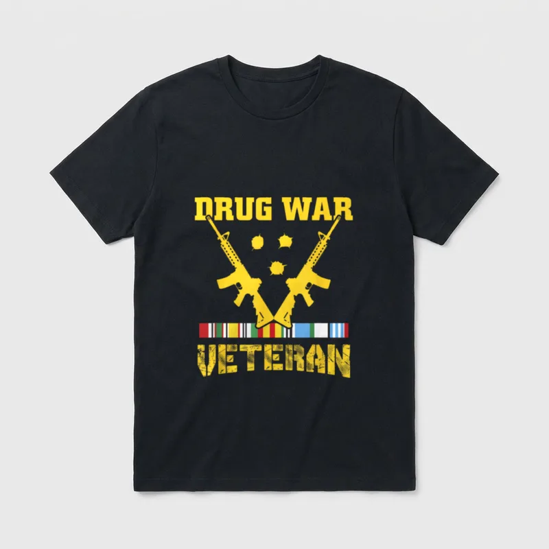 USA Freedom Veteran T-Shirt – DRUG WAR and VETERAN in yellow text with rifles and medal ribbons – Classic T-Shirt in Black